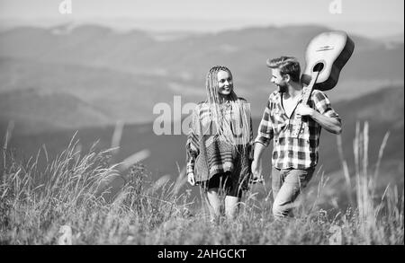 L'amour qui les inspire. Beau couple romantique happy smiling faces fond nature. Petit ami et petite amie avec la guitare. Randonnées romantiques. L'air frais et pur des sentiments. Promenade romantique. Chanson romantique. Banque D'Images