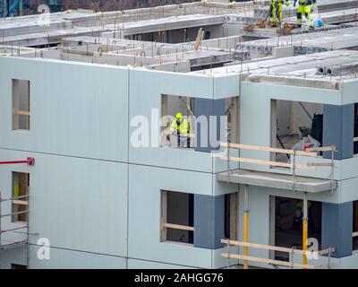 Builders avec grue à étages de construction maison. Hiver ou automne fond. Les travailleurs des constructeurs avec grue sur un appartement maison. Sous ciel bleu du concept d'entreprise. Banque D'Images