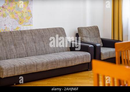 La table gris et noir et une chaise sur le plancher en bois dans la salle de séjour. Close-up. Banque D'Images