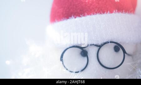 Résumé de jouets en face du Père Noël avec des lunettes rondes et red hat, gros plan les yeux. Banque D'Images