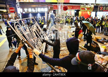 Hong Kong, Chine. 31 Dec, 2019. Des milliers de manifestants anti-gouvernementaux de prendre la rue et de protestation dans plusieurs centres commerciaux sur le jour de l'an. Ici érigent des barrages routiers pour occuper Nathan Road en utilisant les décorations de Noël. Gonzales : Crédit Photo/Alamy Live News Banque D'Images