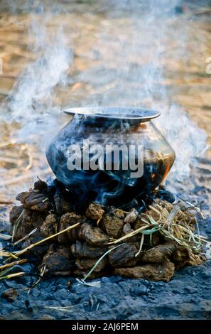 La cuisson dans une casserole en feu en cameldung séché au cours de Pushkar Camel Fair, l'un des plus grands marchés de chameau en Asie Banque D'Images