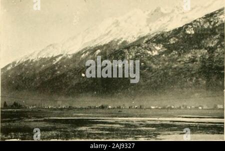 L'Alaska, ses eaux, à la terre et de la vie ; une conférence illustrée . sur elle. En raison, toutefois, de la près de pluies incessantes,la voie est boueuse et glissante, et la partie courte de la route qui a beencorduroj ofiers ed-légère les facilités de déplacements. À Skagway et Dyea, tout est tumulte et confusion. Log et le bois des baraques, auquel le marchandisage est menée et salles avec tables de jeu sont conservés, et tentsgalore avec dispositions empilés dans des sacs de toile, beaucoup d'entre eux d'un coup, anidle dans les groupes de population sur les villes, en attente d'accords parfaits pour startingover le passe, Banque D'Images