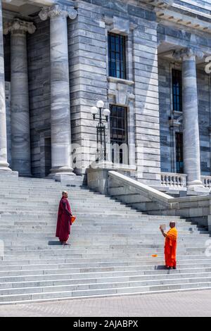 Les moines bouddhistes en prenant des photographies selfies sur les marches de la Maison du Parlement, Wellington, Nouvelle-Zélande Banque D'Images