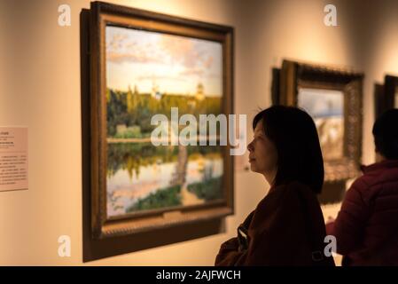 Shanghai, Chine : Asian Woman, visiteur de musée à la recherche d'un tableau encadré sur l'affichage, exposition d'art au musée de Shanghai Banque D'Images