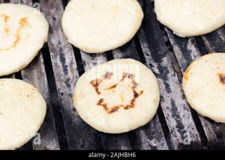 Les arepas grillées cuisson sur le grill Banque D'Images