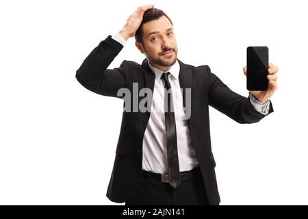 Malheureux businessman holding sa tête et montrant un téléphone mobile isolé sur fond blanc Banque D'Images