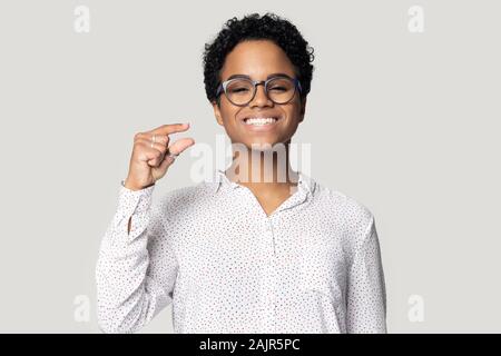 Femme africaine montrant avec les doigts quelque chose de petit studio shot Banque D'Images