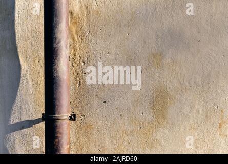 Gouttière sur un mur d'une maison. Banque D'Images