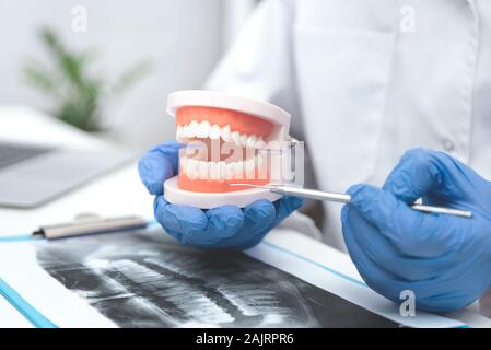 Le médecin de l'office organise la mâchoire. Dentiste montre comment prendre soin de la santé des dents Banque D'Images