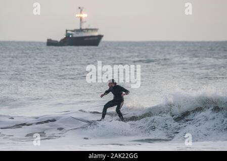 Un homme surf au large de la côte de l'Ano Nuevo State Park dans le comté de San Mateo en Californie. Banque D'Images