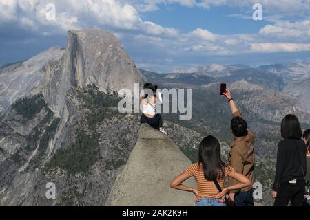 Des amis prenant des selfies et des photos de voyage à Half Dome point de vue, Californie Banque D'Images