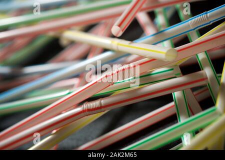 Des pailles en plastique de boisson sur un tableau noir. Banque D'Images