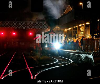 Réplique moderne machine à vapeur en gare de Lincoln dans la nuit avec un train des adeptes. Banque D'Images