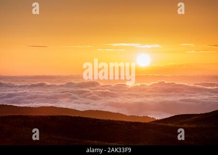 Le lever du soleil sur la plaine vénitienne, avec vague de nuages. Vue depuis la montagne, plateau Cansiglio Prealpi Venete. Veneto. L'Italie. L'Europe. Banque D'Images