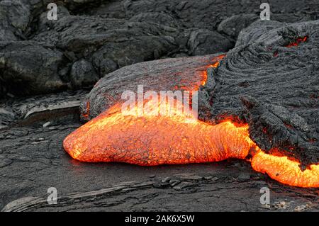 Vue détaillée d'une coulée de magma chaud émerge d'une fissure dans la terre, la lave rougeoyante apparaît dans strong jaunes et rouges - Emplacement : Haw Banque D'Images