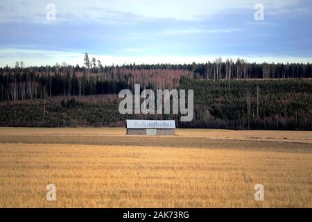 Paysage rural avec lonely grange en bois au milieu du champ sur l'image de l'hiver. Salo, Finlande. Banque D'Images