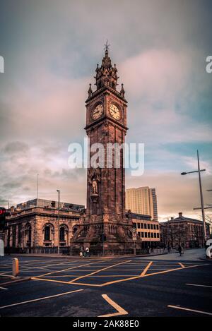 BELFAST, EN IRLANDE DU NORD, LE 19 DÉCEMBRE 2018 : Les gens qui passent par la Queen's Square où Albert Memorial Clock Tower est situé. Achevé en 1869 et est Banque D'Images