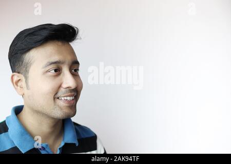 La face latérale d'un jeune homme indien isolé en fond blanc avec copie espace pour le texte. Banque D'Images
