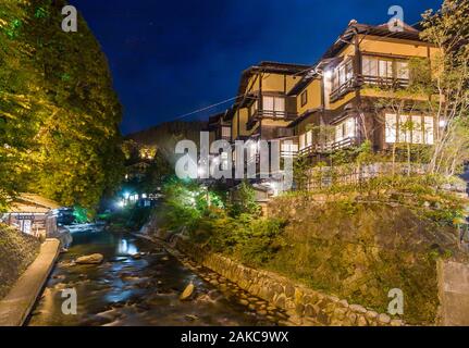 Le Japon, l'île de Kyushu, Région de Kumamoto, Kurokawa Onsen, vue de la nuit de bâtiments fabriqués de matériaux traditionnels, le long de la rivière Banque D'Images