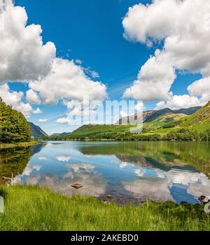 Une belle journée d'été sur le lac Buttermere, en Angleterre, en mettant en évidence les nuages dans l'eau. Banque D'Images