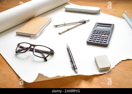 Vue en perspective sur la configuration technique du dessin, avec crayon, compas, règle, calculatrice, lunettes, gomme et bloc-notes Banque D'Images