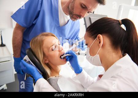 Jeune femme est en traitement au bureau du dentiste Banque D'Images