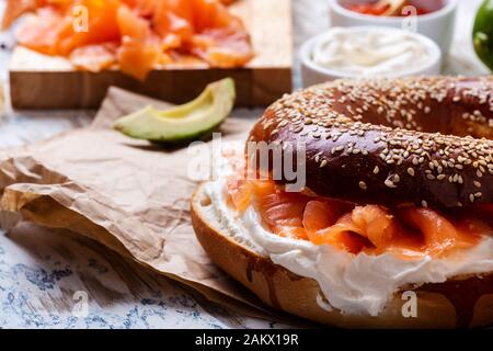 Brunch festif avec saumon fumé servi avec fromage à la crème, bagel, pot de caviar de saumon, avocat, table rustique près Banque D'Images