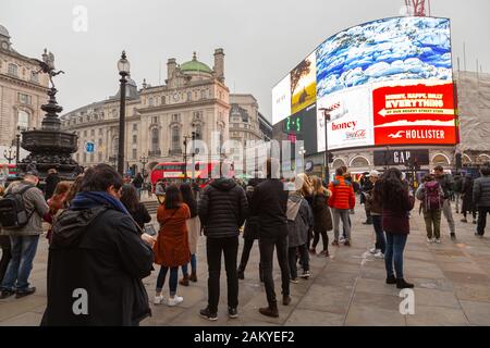 Londres, Royaume-Uni - 31 décembre 2019: Certaines personnes écoutent un buker à Piccadilly Circus Banque D'Images