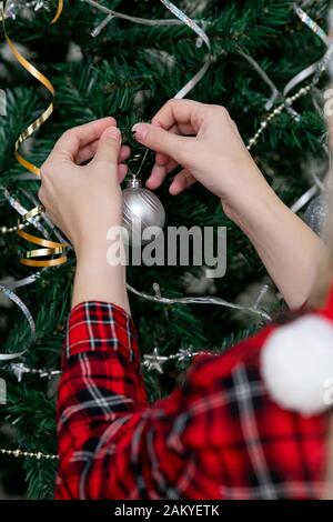 Fille main décorant arbre de Noël Banque D'Images