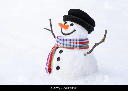 Bonhomme de neige joyeux sur un fond enneigé. Carte de Noël avec un personnage drôle. Jeux d'hiver traditionnels pour les enfants Banque D'Images