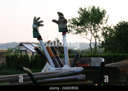 Brouette avec gants de jardinage sur les outils dans le soleil du soir atmosphère proche Banque D'Images