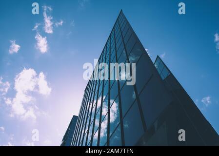 Abstrait architecture fond avec ciel bleu et l'immeuble de bureaux modernes avec reflet dans la fenêtre en verre Banque D'Images