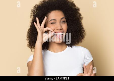 Joyeuse jeune femme afro-américaine montrant un geste correct. Banque D'Images