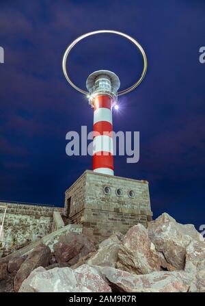 Photographie de longue exposition de lumières formant des formes derrière un phare représentant les feux de drone.Port Burgas bulgarie. Banque D'Images