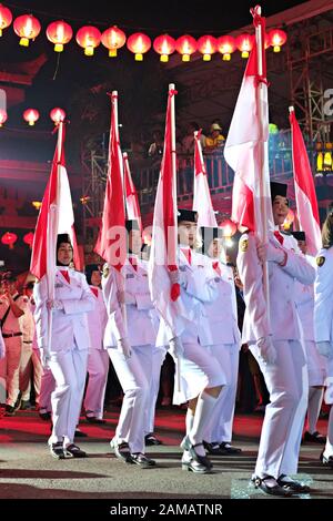 Un groupe d'étudiants du secondaire apporter drapeaux indonésiens en célébration du nouvel an chinois festival. Banque D'Images