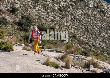 Des randonnées de femmes le long de ridgecrest longent la colline, la montagne El Divino, la province d'Alicante, Costa Blanca, Espagne Banque D'Images