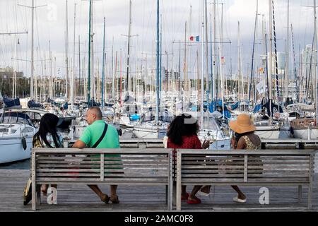 Barcelone, Espagne - 12 septembre 2019, les touristes se reposent entouré de mouettes dans le vieux port de la ville de Barcelone. Banque D'Images