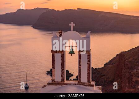 Clocher avec lumière chaude au coucher du soleil à Oia, Santorin, Grèce Banque D'Images
