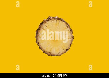 Une tranche ronde d'ananas sur fond jaune. Banque D'Images