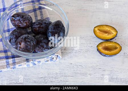Prunes fraîches récoltées au bleu en bois/ arrière-plan arrière-plan alimentaire/ couverts Banque D'Images