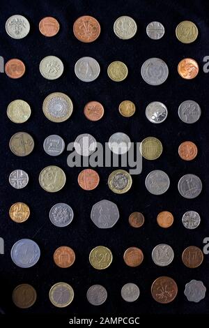 Divers types de pièces de différentes formes, tailles et compositions de différents pays sur fond noir Banque D'Images