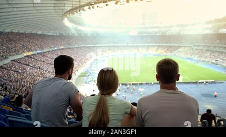 Groupe de fans de football attentivement regarder match au Stadium, l'équipe de soutien Banque D'Images