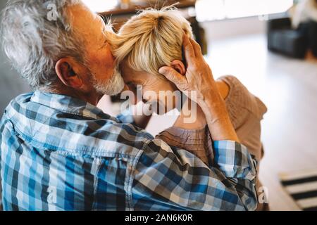 Happy smiling senior couple embracing ensemble à la maison Banque D'Images