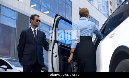 Assistant personnel d'une femme politique d'ouvrir votre porte à son patron, le service Banque D'Images