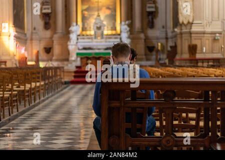 Homme priant dans une église Banque D'Images