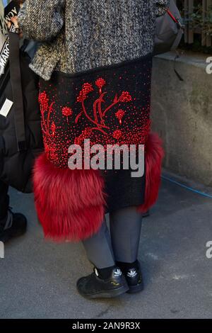 MILAN, ITALIE - 12 janvier 2019 : Femme avec jupe noire avec fourrure rouge détails et décorations florales avant Msgm fashion show, Milan Fashion Week stree Banque D'Images