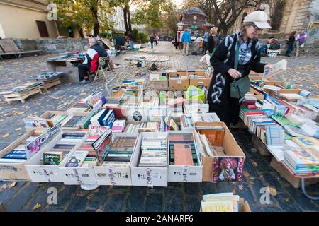 La navigation au travers de boîtes de livres de seconde main au marché aux puces dans les rues de Lviv, Ukraine Banque D'Images