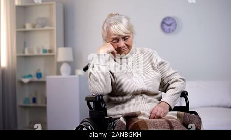 Appuyée de dame en fauteuil roulant la réflexion sur les problèmes de santé à l'hôpital Banque D'Images