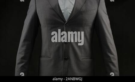 L'homme anonyme en tailleur posant sur l'appareil photo, et de la richesse de la stratégie de réussite Banque D'Images